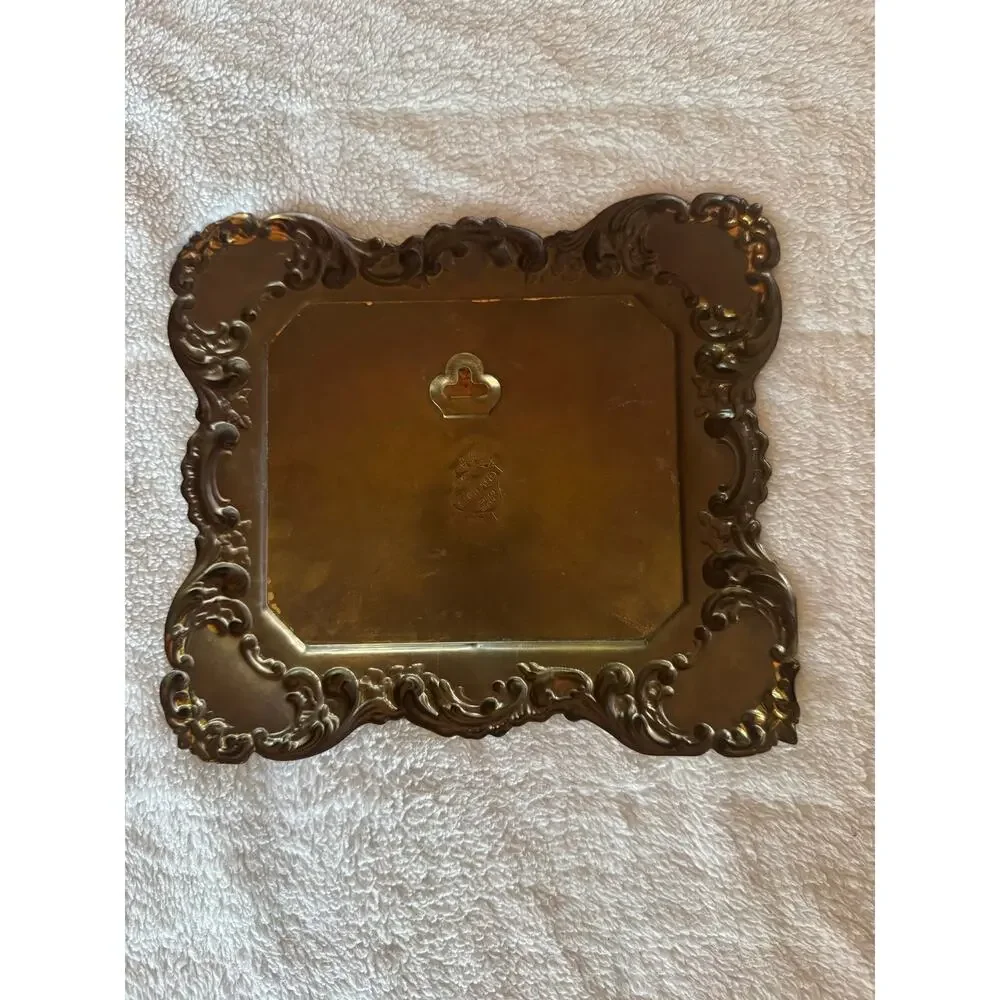 Vintage embossed brass frame with a foil print of an English countryside.
